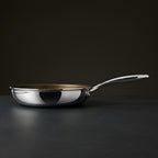Side view of the Pure Pan with mirror-polished stainless steel walls and stay-cool handle