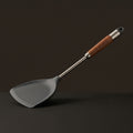 Still spatula with a stainless steel shaft and wood grip
