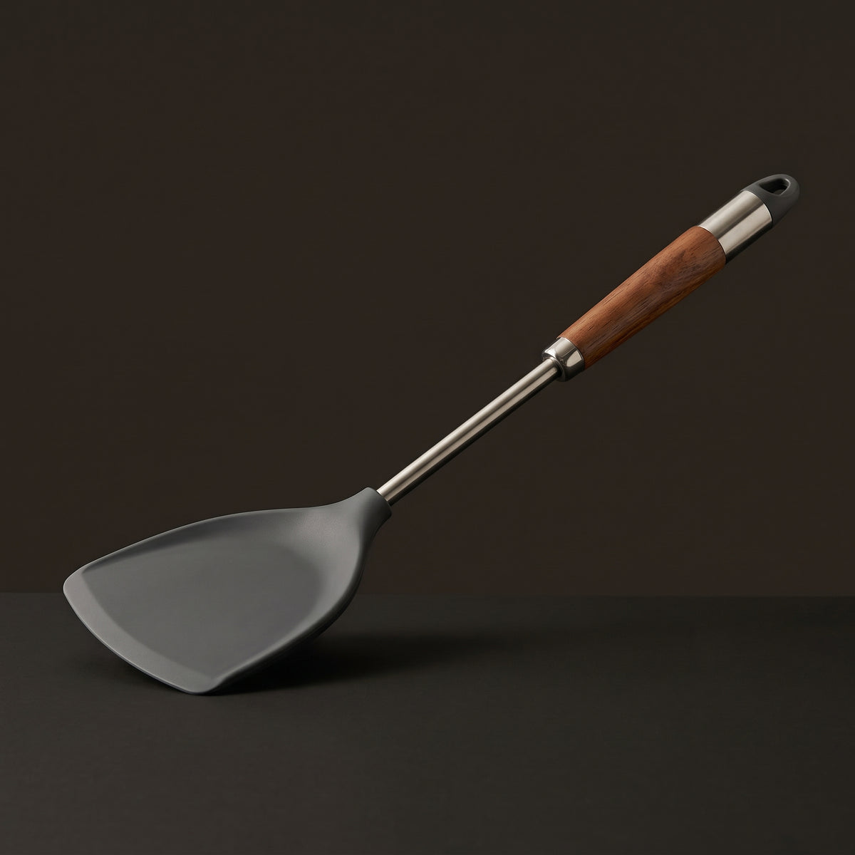 Still spatula with a stainless steel shaft and wood grip