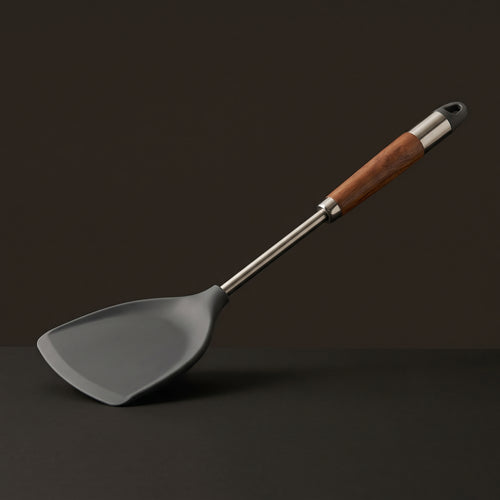 Still spatula with a stainless steel shaft and wood grip